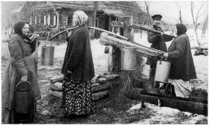 Russian peasants in pre-Revolution Russia draw water from a well.