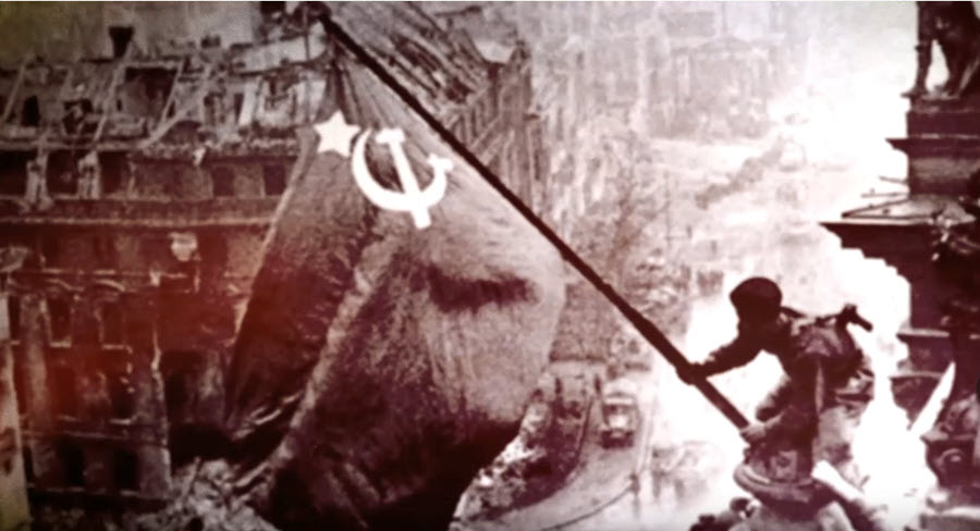Soviet soldier raising flag over German Reichstag, 1945
